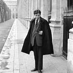 Leonard in suite and coat on Paris Street