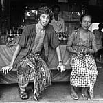 1973 Leonard Sitting on Bench with Woman in Bali