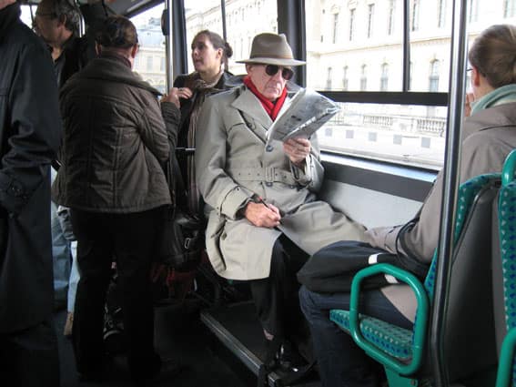 Sam Spade in Retirement in Paris Doing a Crossword Puzzle on the Bus